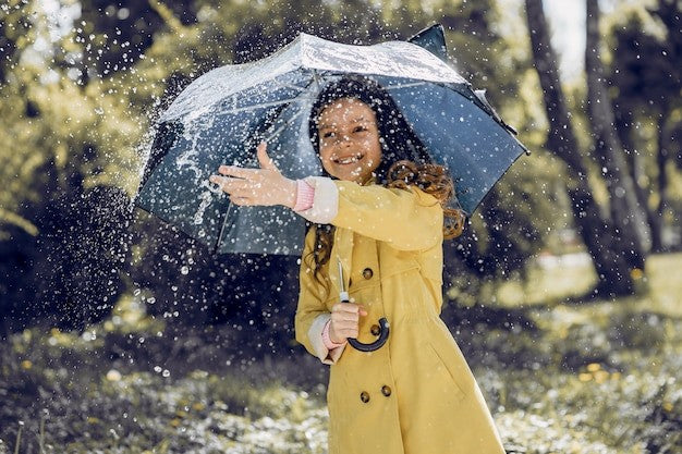 Cute kid playing on a rainy day